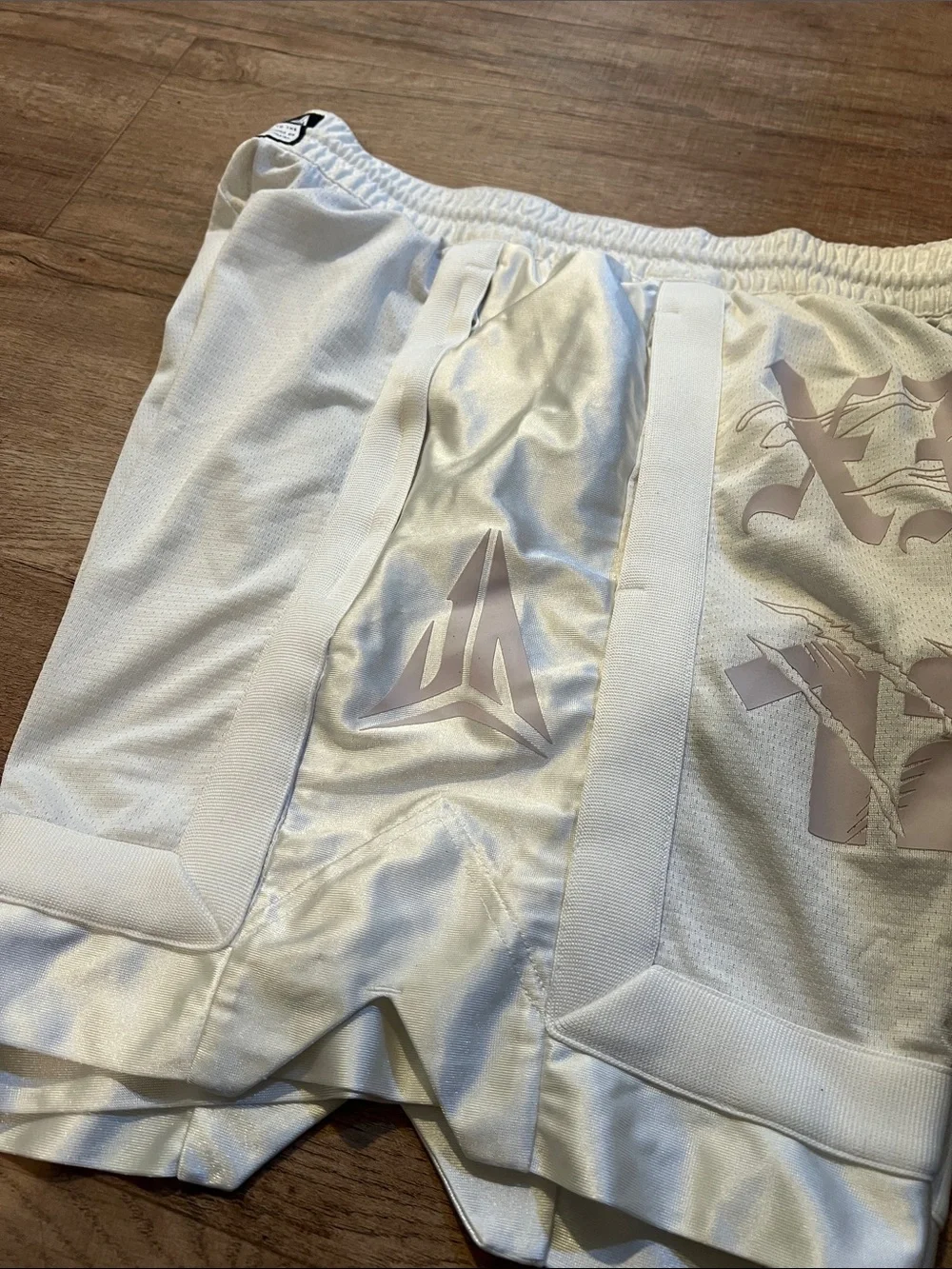 Nike Men’s White Athletic Shorts with Pale Pink Graphic